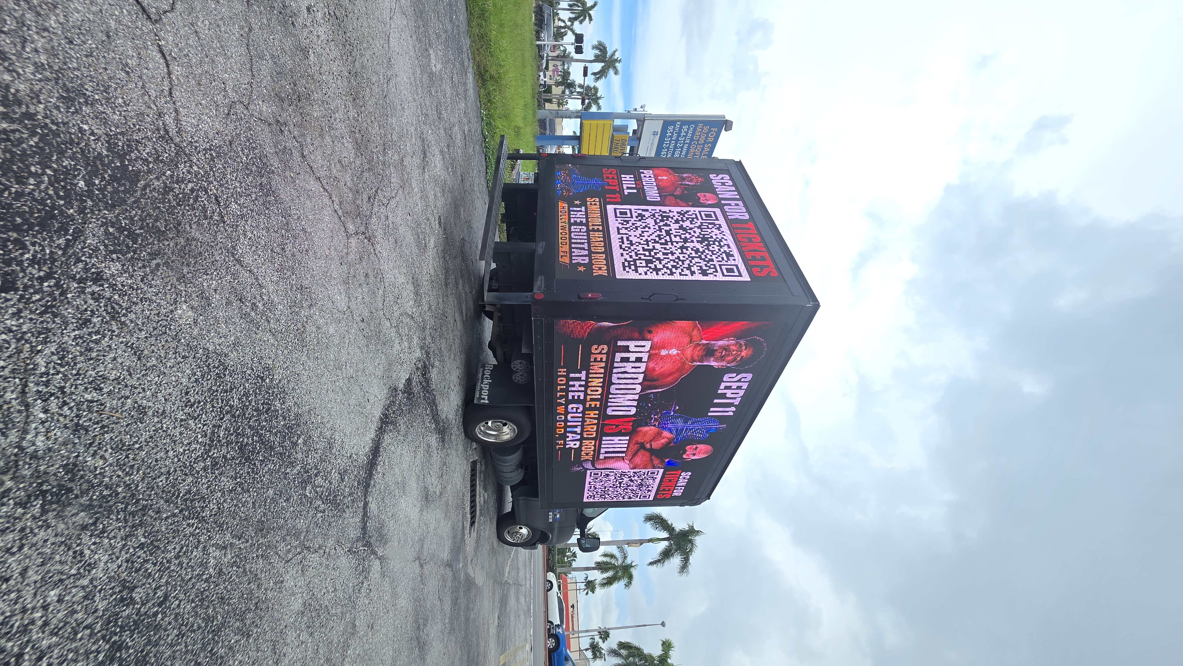 Full view of the truck displaying the Perdomo vs Hill event campaign on its LED screens